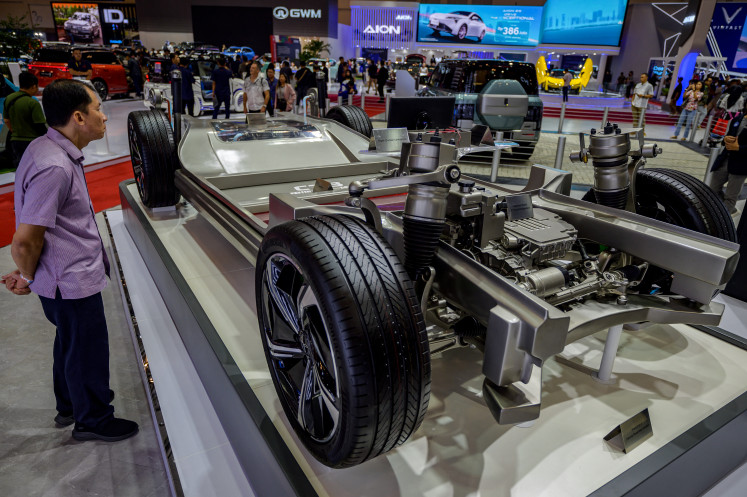 A visitor looks at the chassis of an electric vehicle (EV) on July 18 at the Gaikindo Indonesia International Auto Show 2024 in Tangerang, Banten.